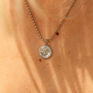 small silver white St. Christopher close up 
