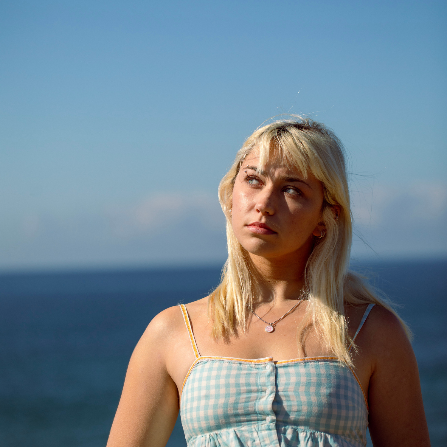 model wearing small pink white st. christopher 