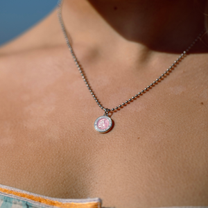 small pink white st. christopher on model neck