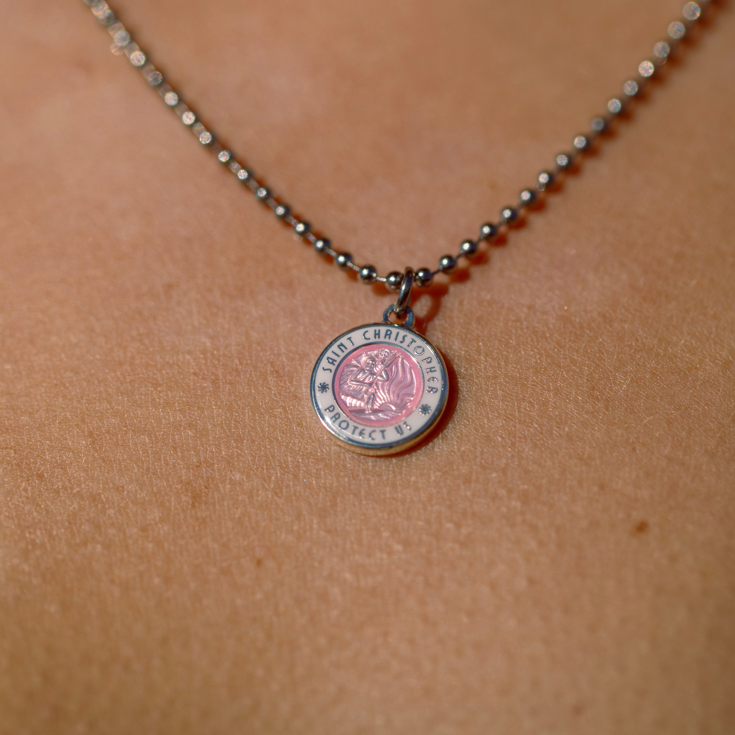 close of up of small pink white st. christopher 