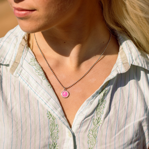 small fuchsia pink st. christopher on model neck
